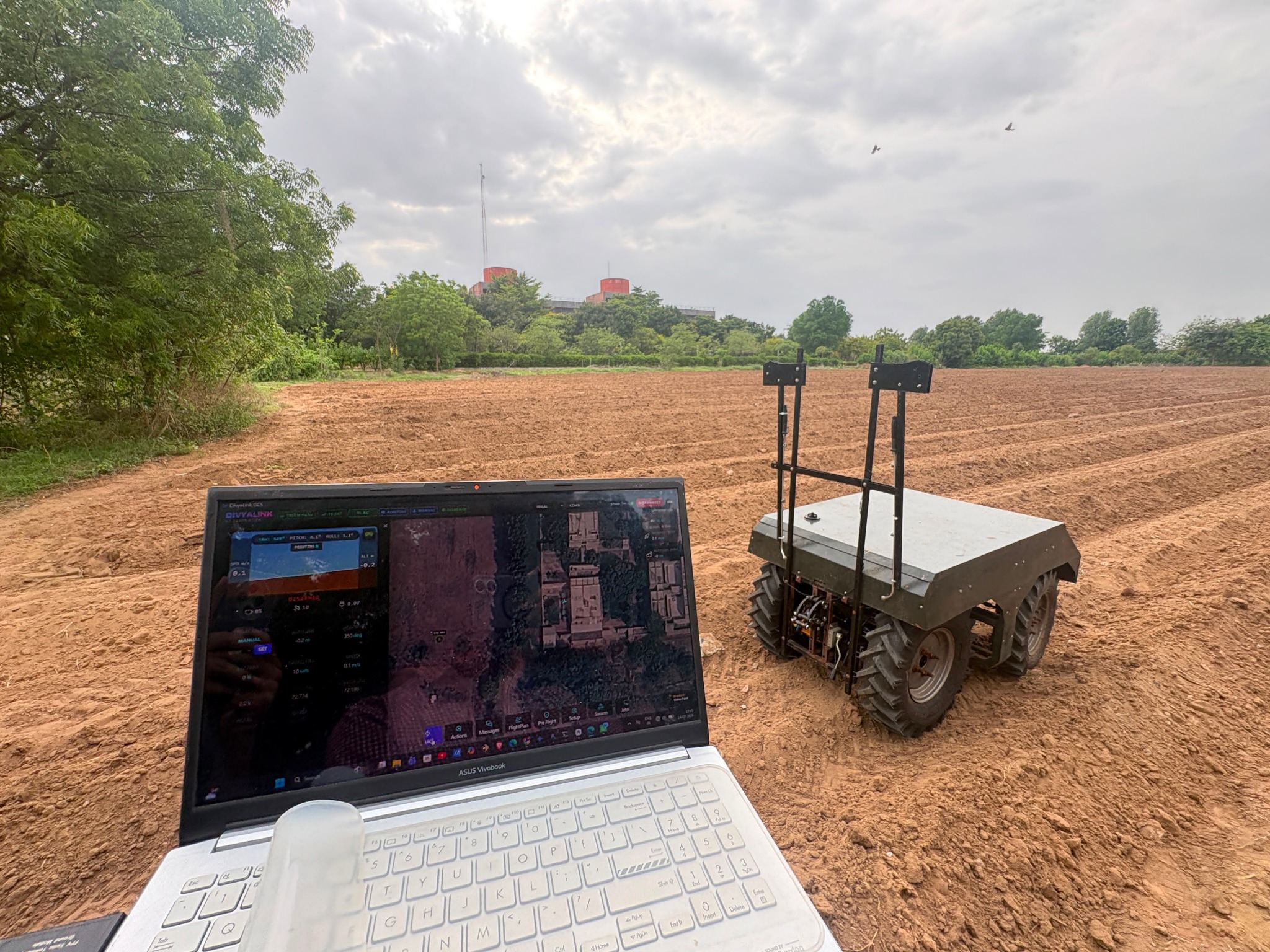 Agrover electric rover beside a laptop during a field trial.